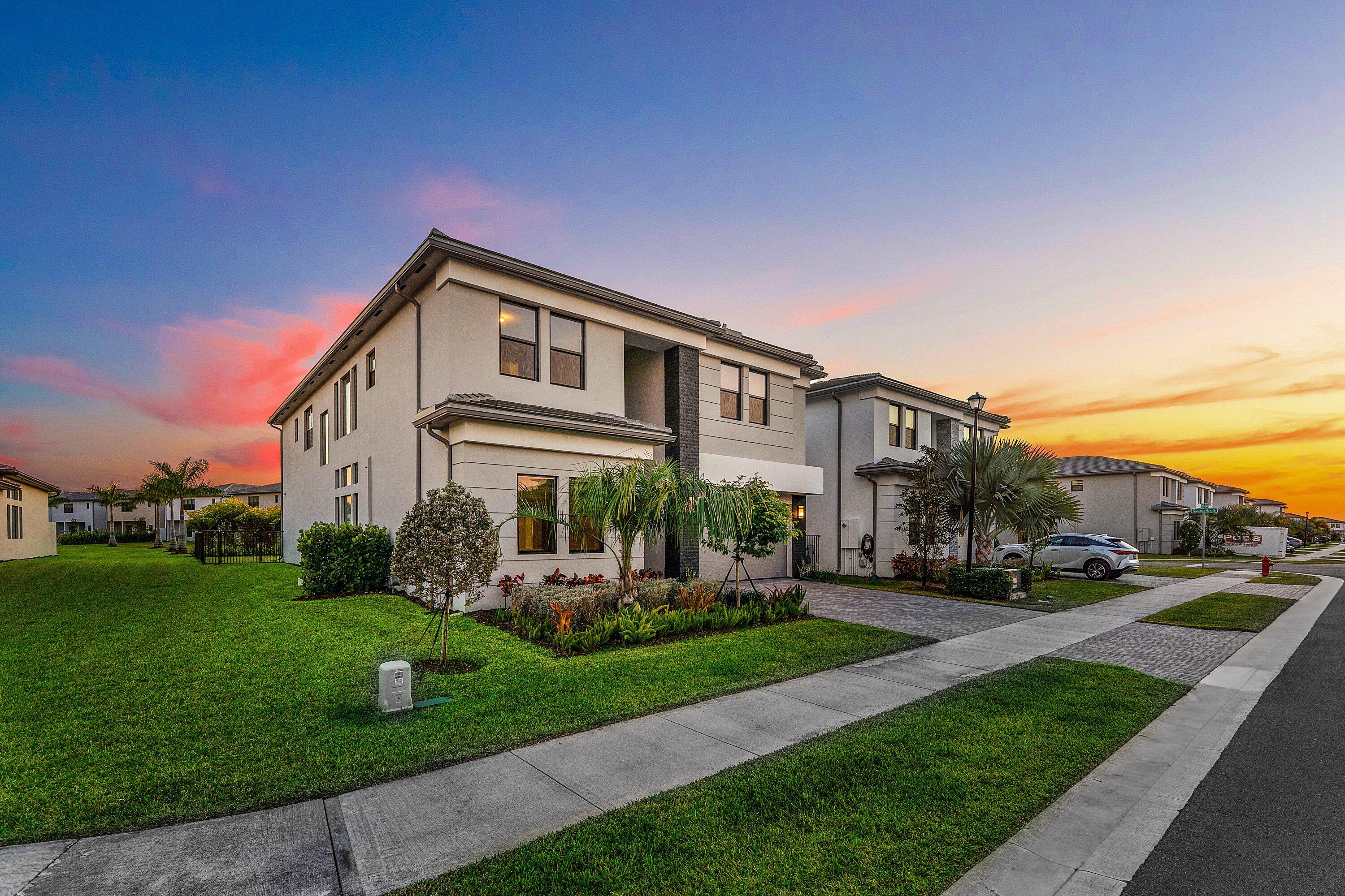 8260 Royal County Down Road Boca Raton, FL 33434 - Photo 74 of 115 a front view of a house with a yard