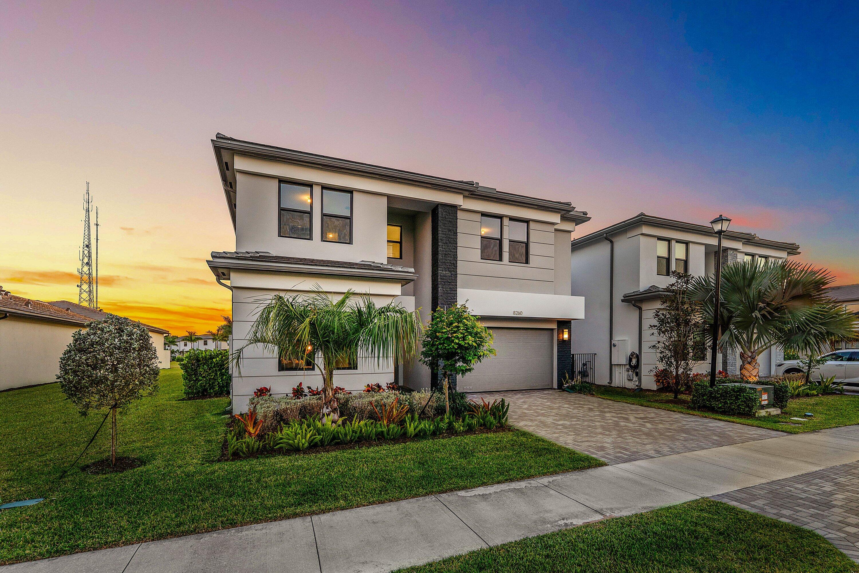 8260 Royal County Down Road Boca Raton, FL 33434 - Photo 76 of 115 a front view of a house with a garden and plants