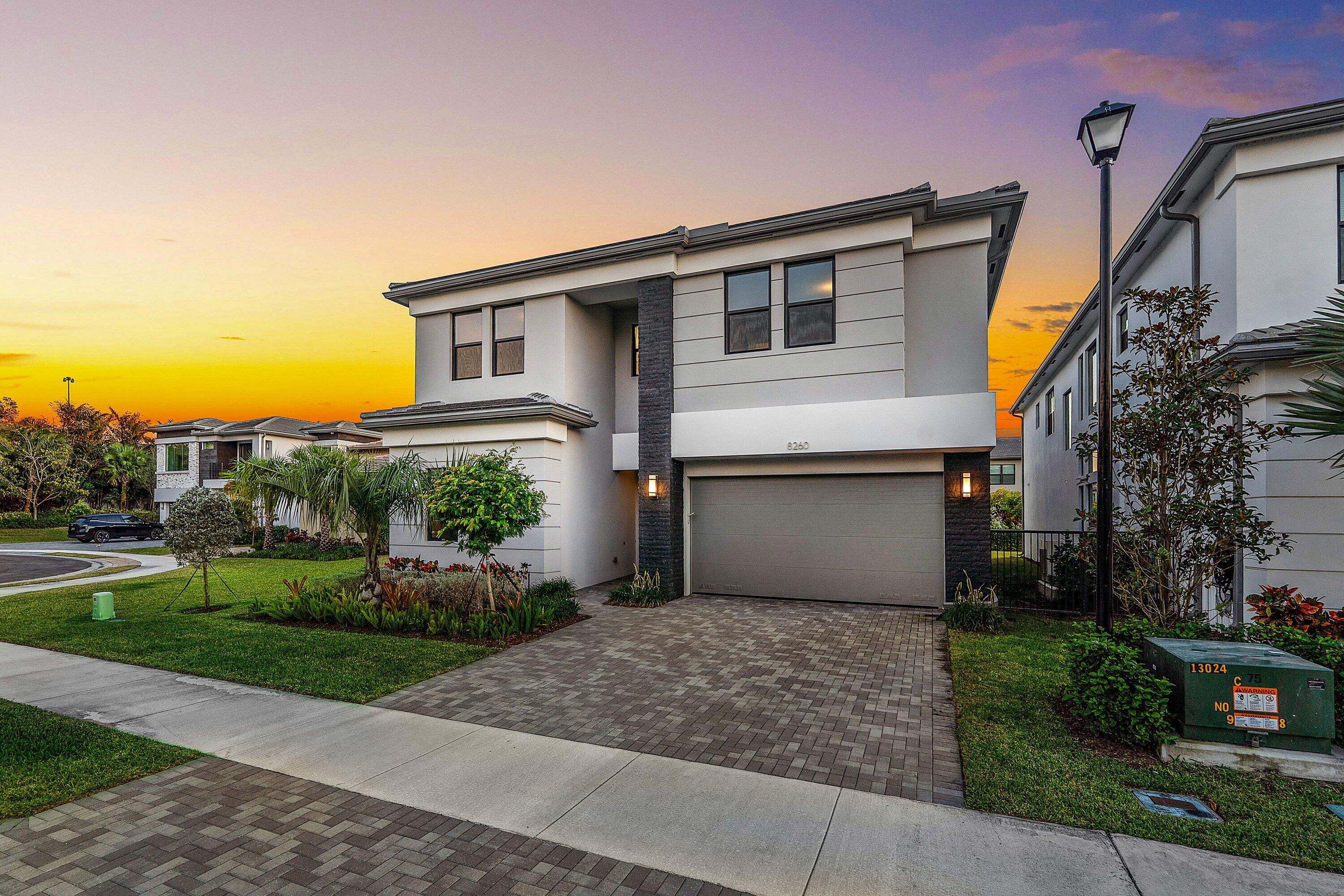 8260 Royal County Down Road Boca Raton, FL 33434 - Photo 77 of 115 a front view of a house with a garden