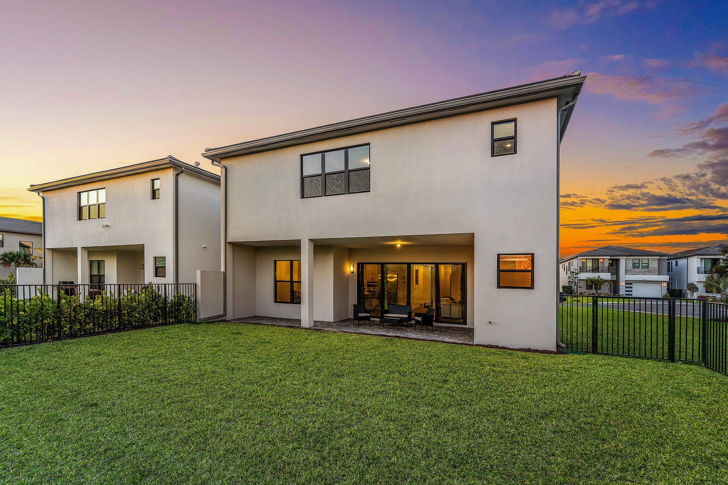 8260 Royal County Down Road Boca Raton, FL 33434 - Photo 79 of 115 a front view of a house with a yard and outdoor seating