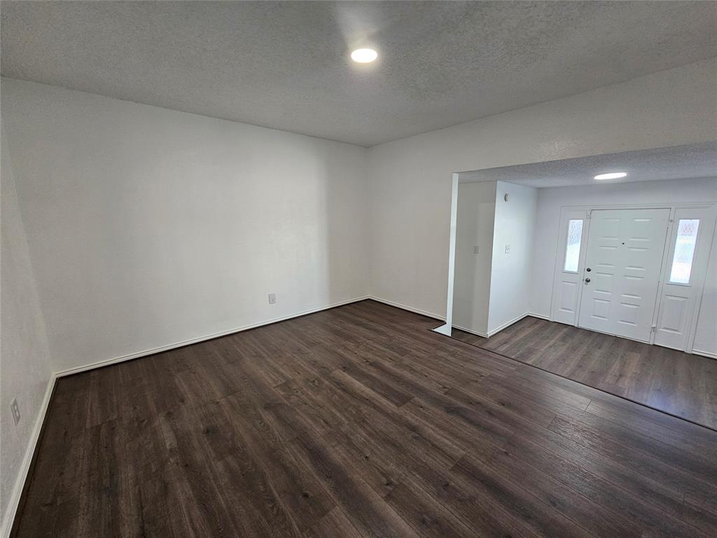 2400 Meadow Creek Drive Carrollton, TX 75006 - Photo 14 of 33 a view of an empty room and wooden floor