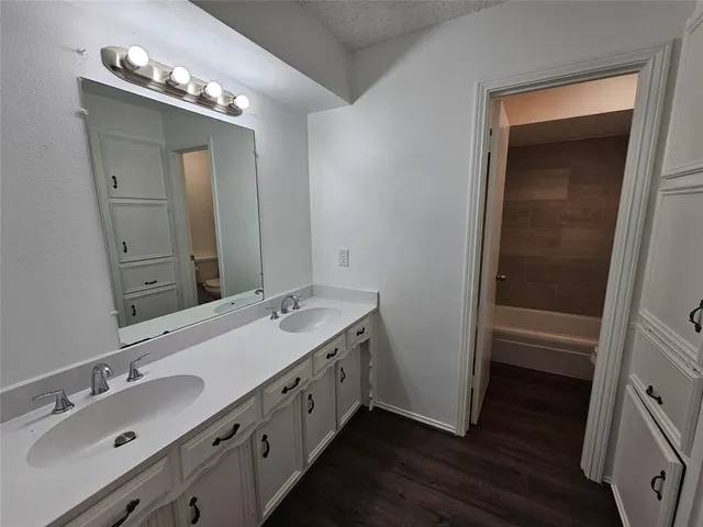 a bathroom with a double vanity sink and a mirror