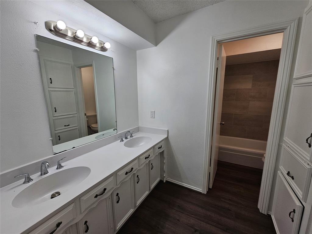 2400 Meadow Creek Drive Carrollton, TX 75006 - Photo 17 of 33 a bathroom with a double vanity sink and a mirror