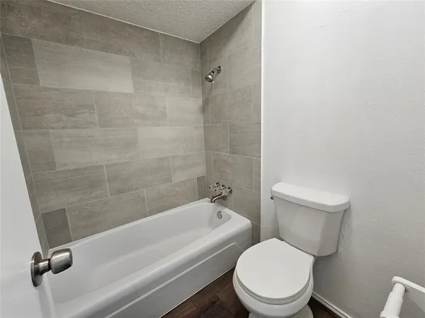 a white toilet and tub sitting next to a bathroom sink