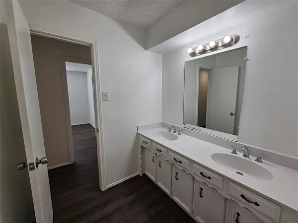 a bathroom with a double vanity sink and mirror
