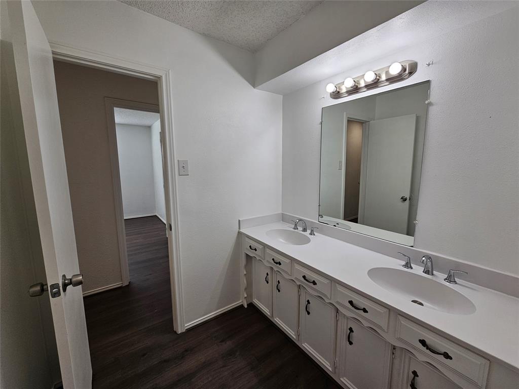 2400 Meadow Creek Drive Carrollton, TX 75006 - Photo 19 of 33 a bathroom with a double vanity sink and mirror