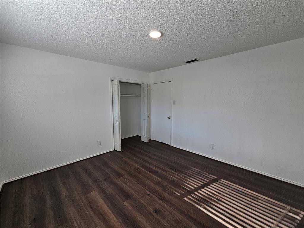 2400 Meadow Creek Drive Carrollton, TX 75006 - Photo 21 of 33 a view of an empty room with wooden floor
