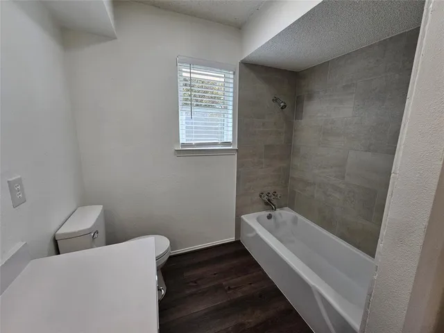 a bathroom with a bathtub and shower