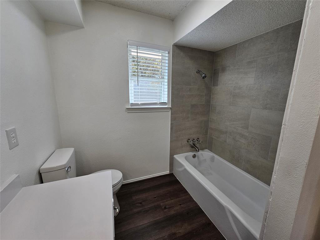 2400 Meadow Creek Drive Carrollton, TX 75006 - Photo 25 of 33 a bathroom with a bathtub and shower