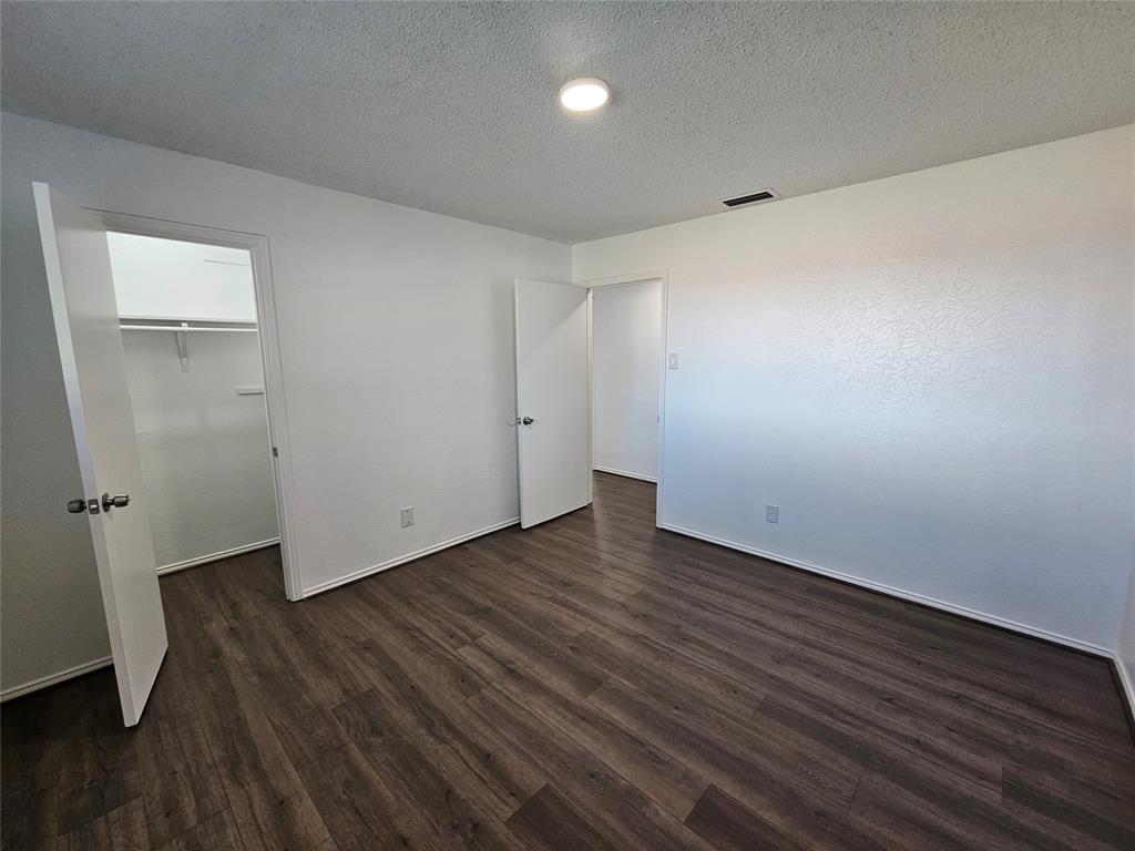 2400 Meadow Creek Drive Carrollton, TX 75006 - Photo 27 of 33 an empty room with wooden floor and windows