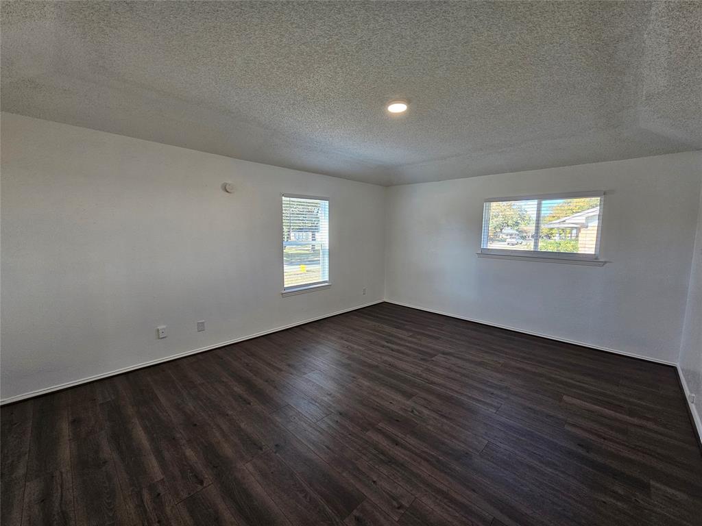 2400 Meadow Creek Drive Carrollton, TX 75006 - Photo 30 of 33 a view of an empty room with wooden floor and a window