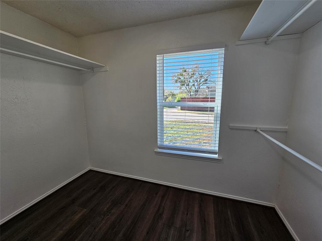 2400 Meadow Creek Drive Carrollton, TX 75006 - Photo 32 of 33 a view of an empty room with wooden floor and a window