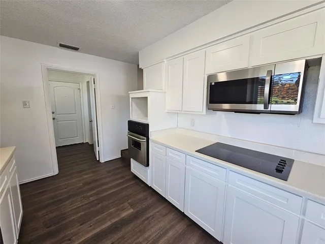 a kitchen with a refrigerator and a microwave