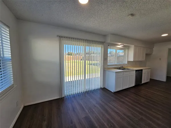 a large kitchen with a large window a sink and stainless steel appliances