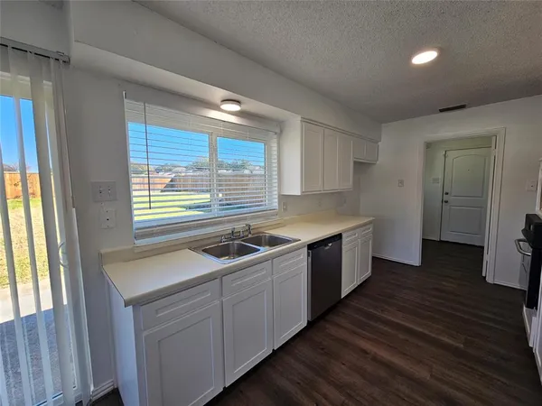 a kitchen with a sink stove and cabinets