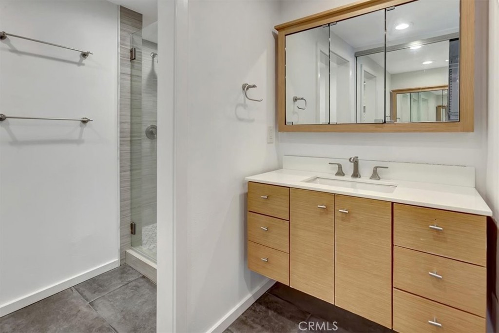 363 Ravello Lane Costa Mesa, CA 92627 - Photo 11 of 22 a bathroom with a sink and a mirror