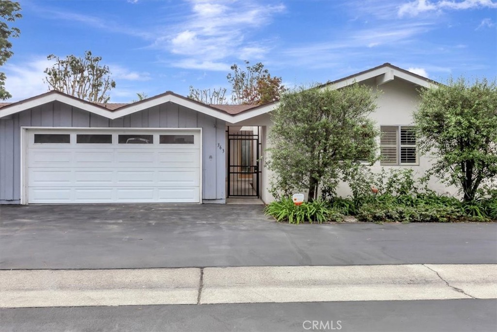 363 Ravello Lane Costa Mesa, CA 92627 - Photo 22 of 22 a front view of a house with a yard and garage