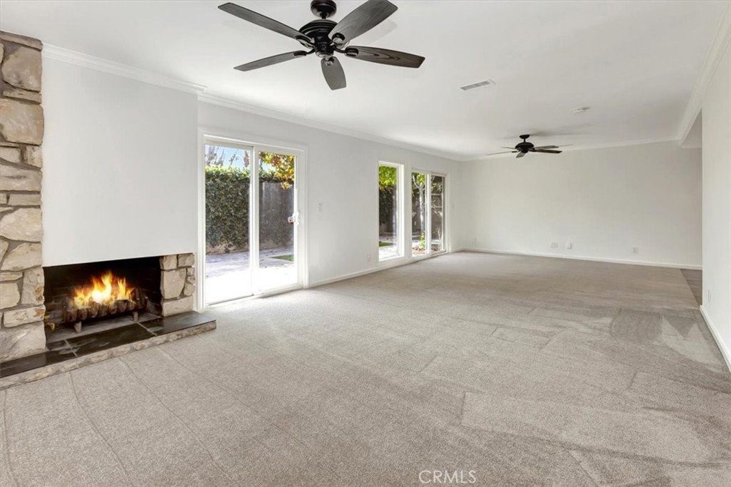 363 Ravello Lane Costa Mesa, CA 92627 - Photo 7 of 22 a view of an empty room with a fireplace