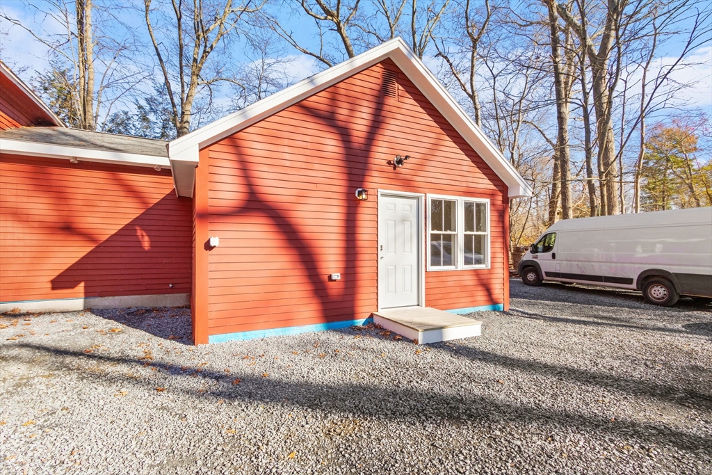 a view of a house with a yard and sitting area
