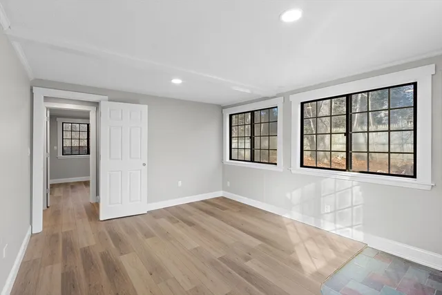 wooden floor in an empty room with a window