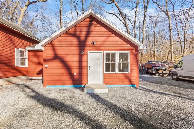 a view of a house with a yard and garage