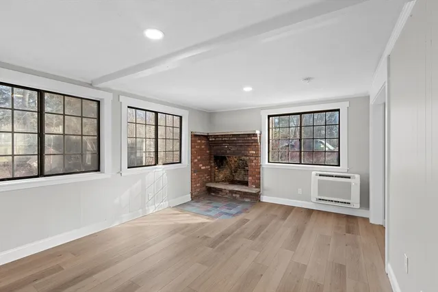 wooden floor in an empty room with a window