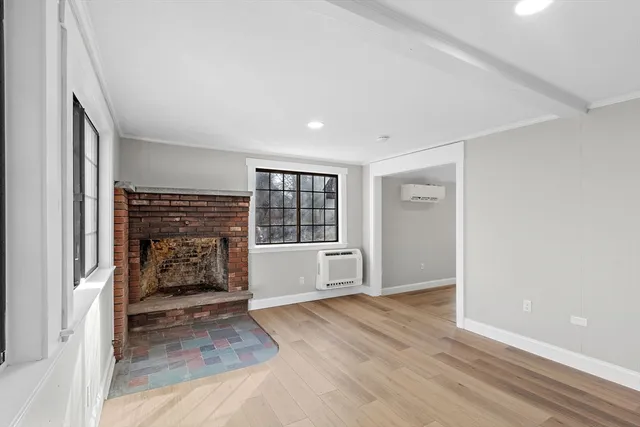wooden floor in an empty room with a fireplace
