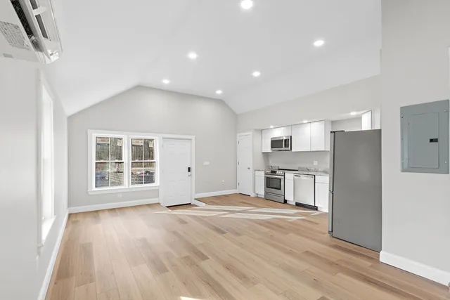 a view of a kitchen with a sink and a refrigerator