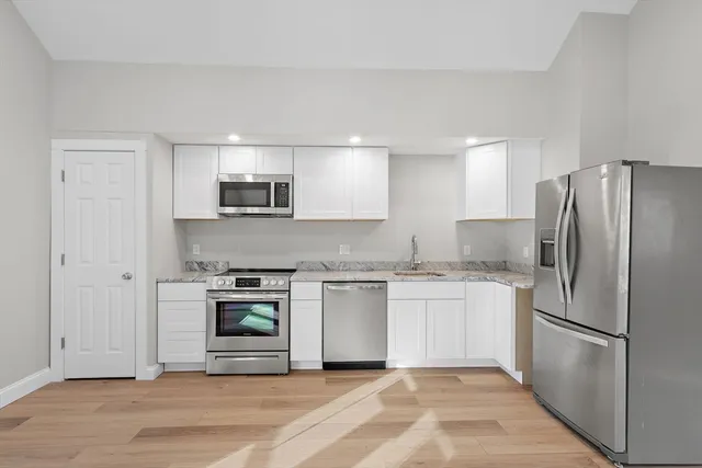 a kitchen with a refrigerator stove and microwave