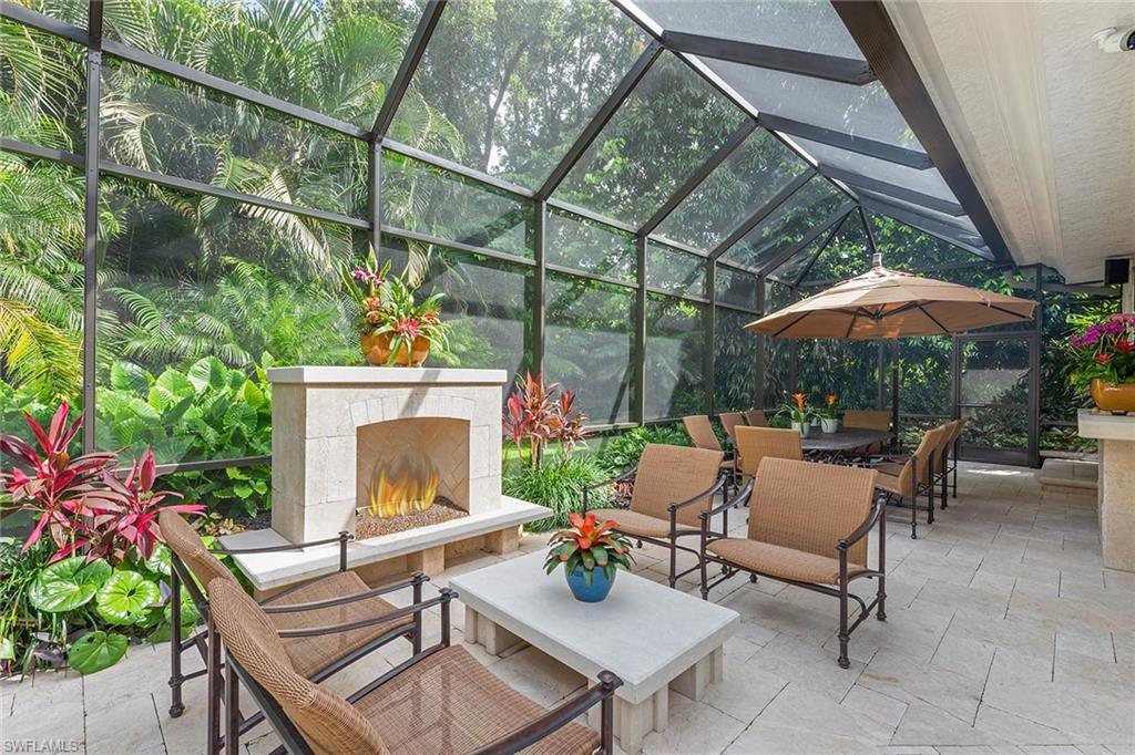 809 Buttonbush Lane Naples, FL 34108 - Photo 11 of 23 a backyard of a house with table and chairs