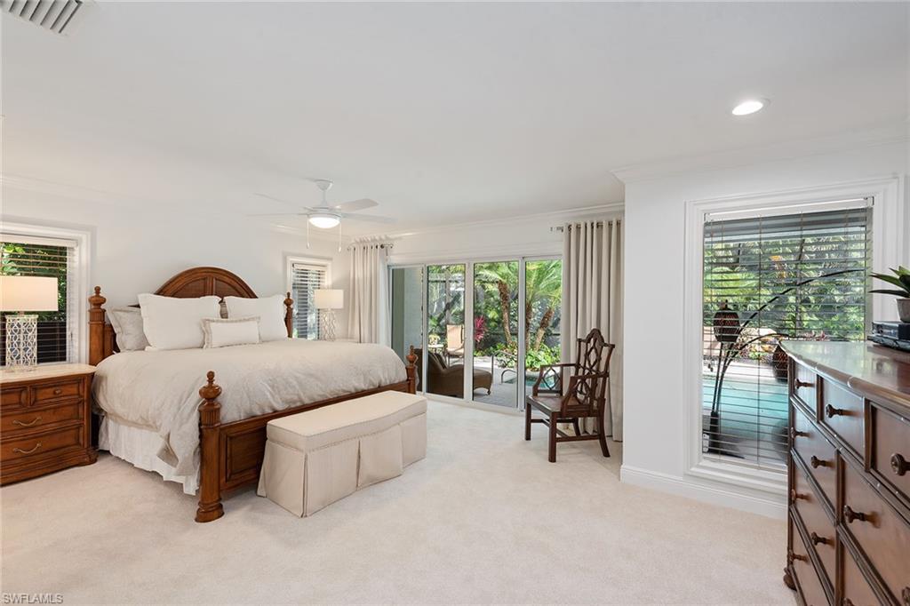 809 Buttonbush Lane Naples, FL 34108 - Photo 13 of 23 a bedroom with a bed and a large window