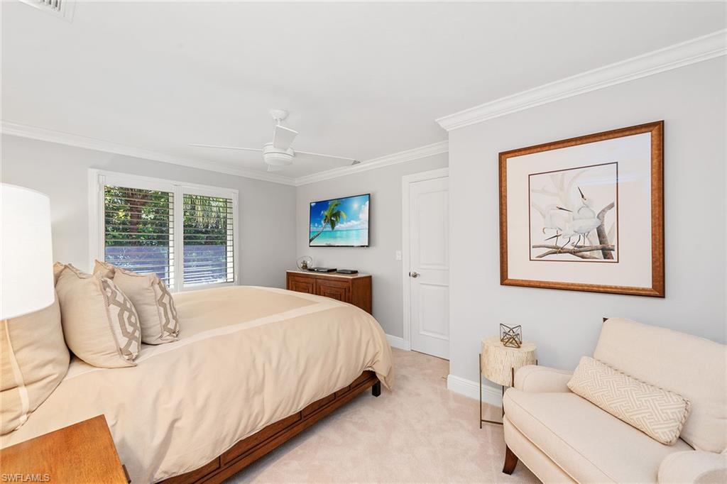 809 Buttonbush Lane Naples, FL 34108 - Photo 18 of 23 a bedroom with a bed and a painting on the wall