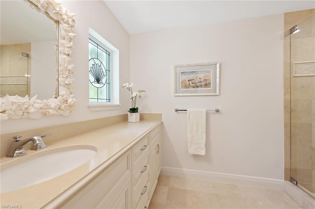 809 Buttonbush Lane Naples, FL 34108 - Photo 19 of 23 a bathroom with a tub sink and mirror