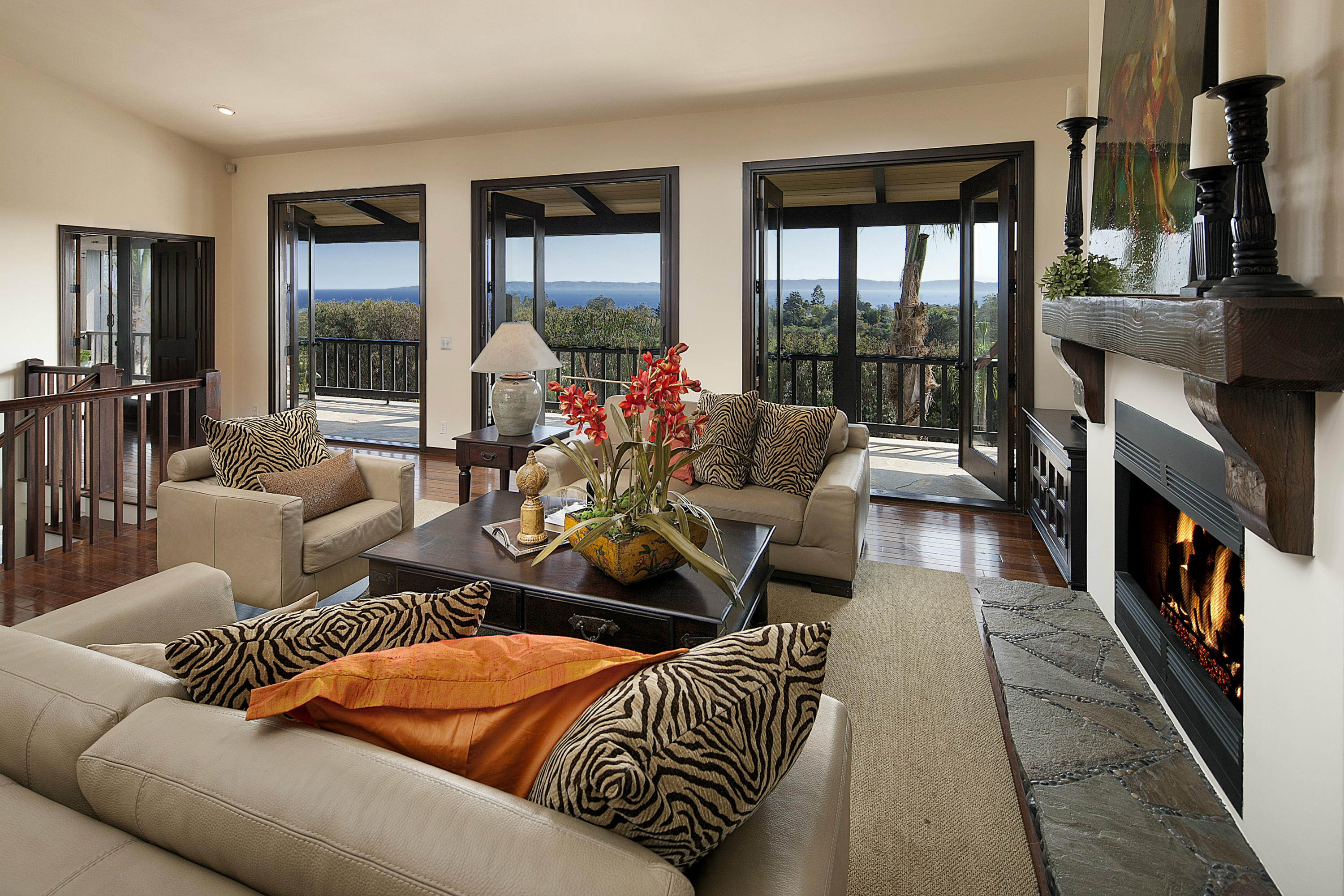 340 Toro Canyon Road Carpinteria, CA 93013 - Photo 1 of 14 a living room with furniture fireplace and a large window