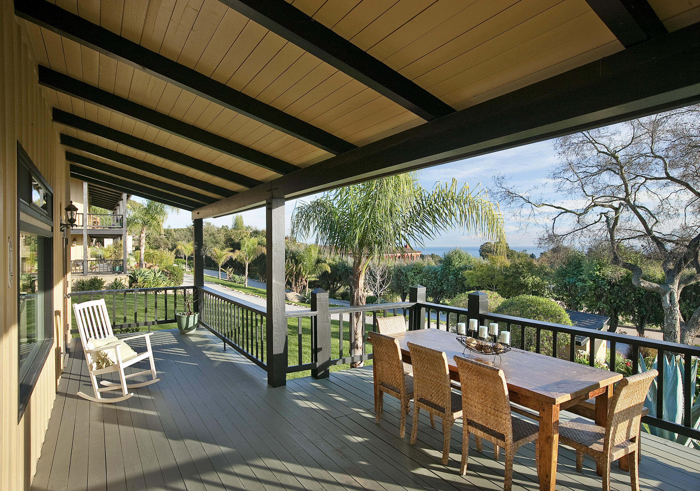 340 Toro Canyon Road Carpinteria, CA 93013 - Photo 14 of 14 a view of a chairs and table in patio with a small yard