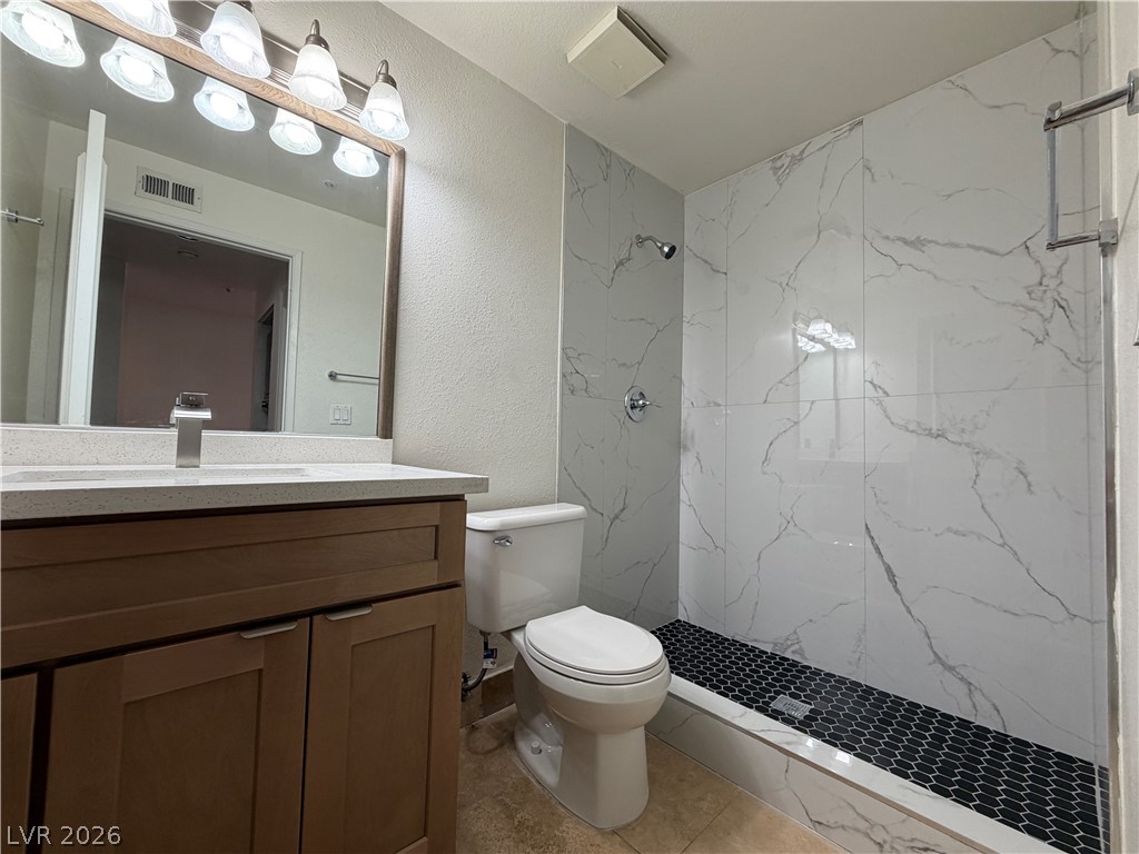 210 East Flamingo Road, Unit 126 Las Vegas, NV 89169 - Photo 15 of 16 Modern bathroom featuring a stylish vanity with ample storage and a sleek walk-in shower.