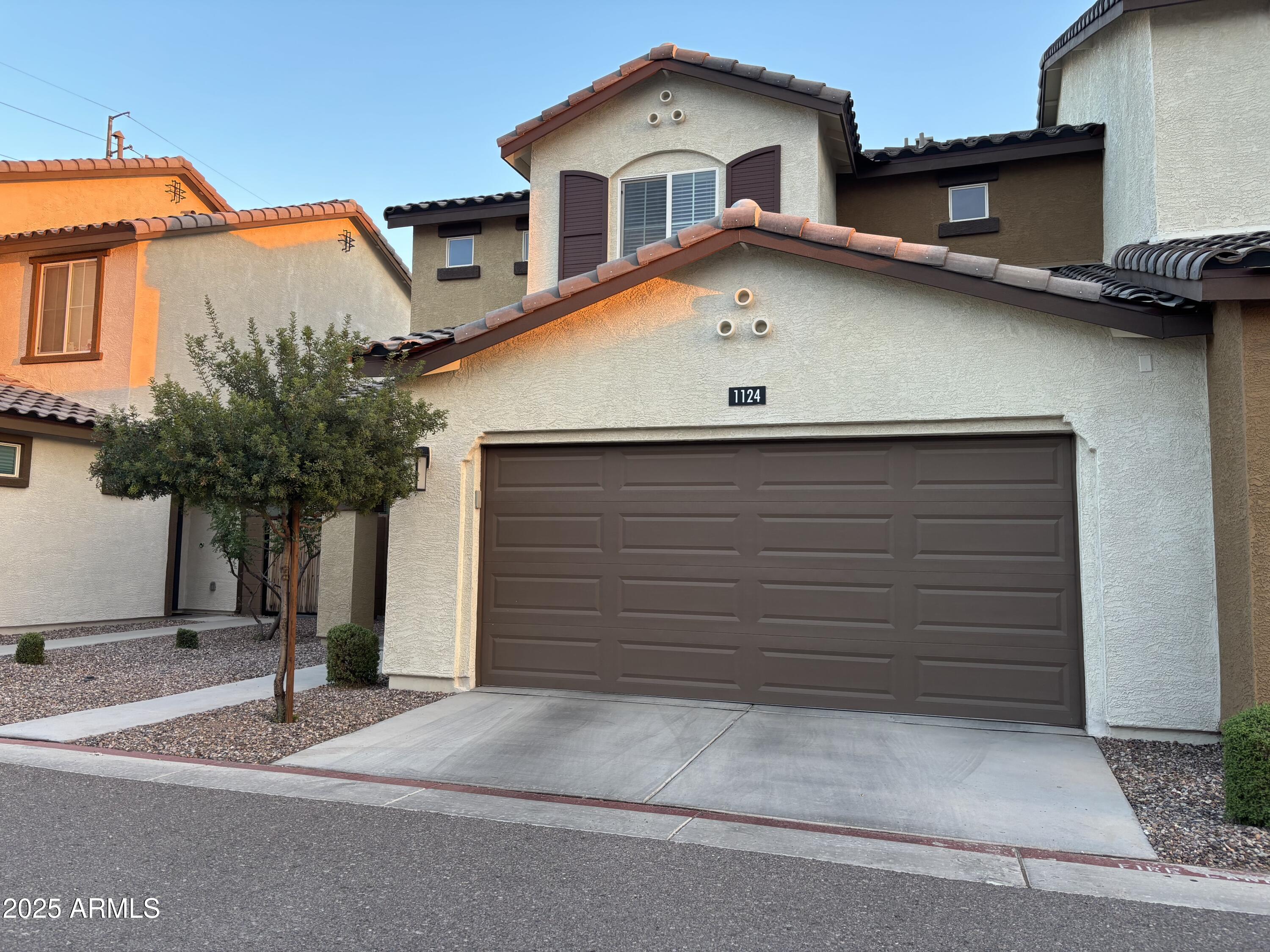 a front view of a house with a yard and garage