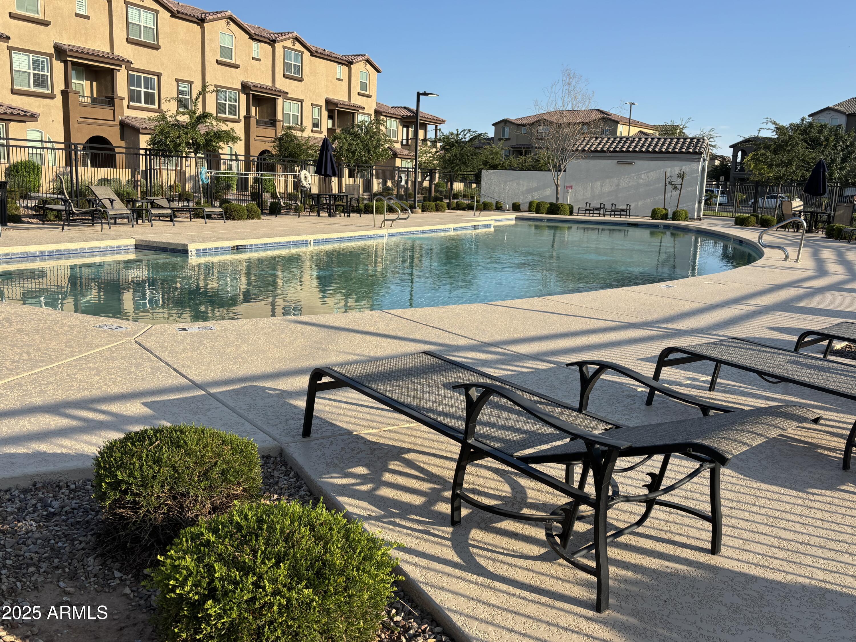 1255 North Arizona Avenue, Unit 1124 Chandler, AZ 85225 - Photo 18 of 29 a view of a lake with a table and chairs