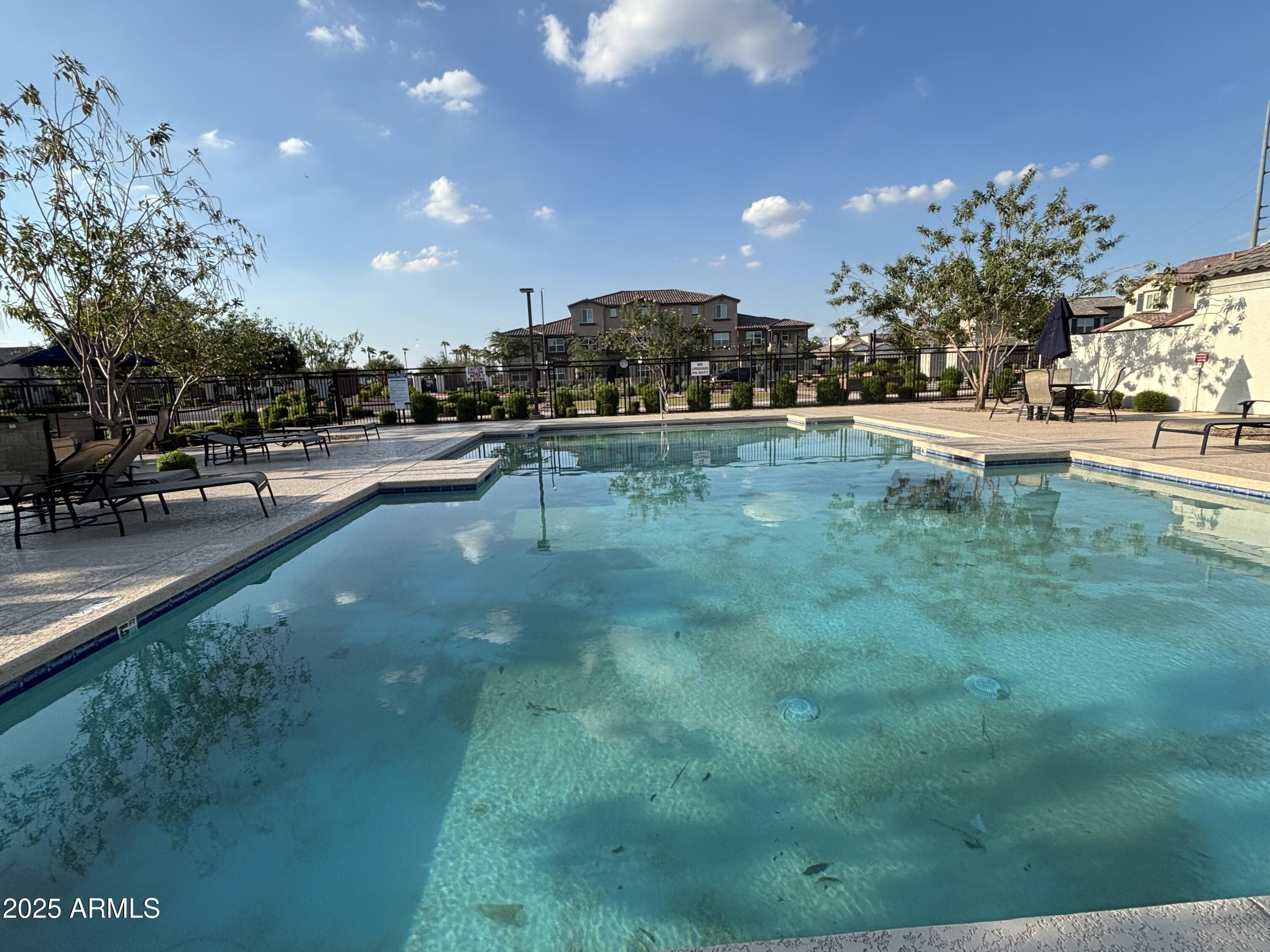 1255 North Arizona Avenue, Unit 1124 Chandler, AZ 85225 - Photo 20 of 29 a view of a swimming pool with a table and chairs