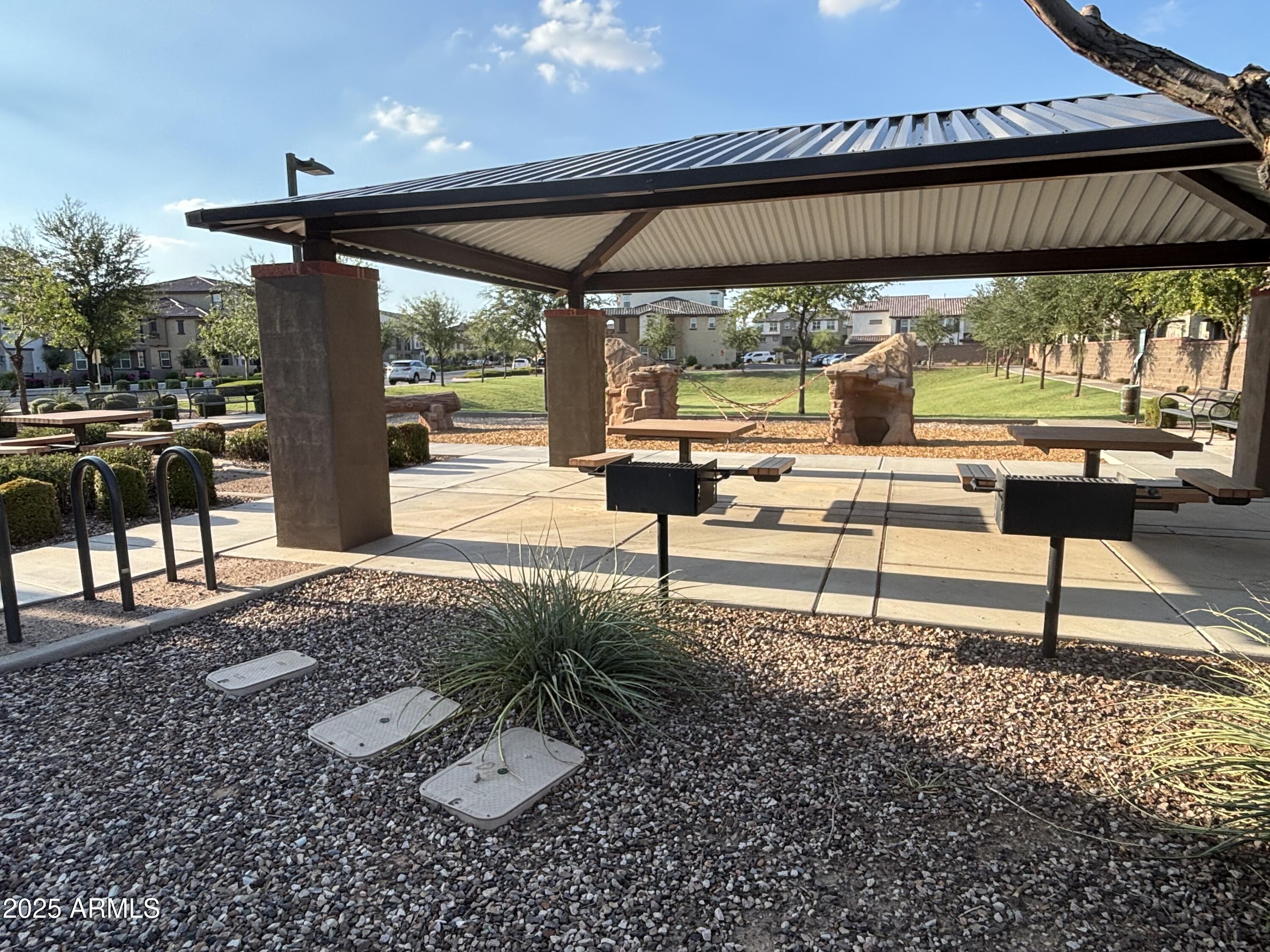 1255 North Arizona Avenue, Unit 1124 Chandler, AZ 85225 - Photo 23 of 29 a view of a porch with chairs and backyard
