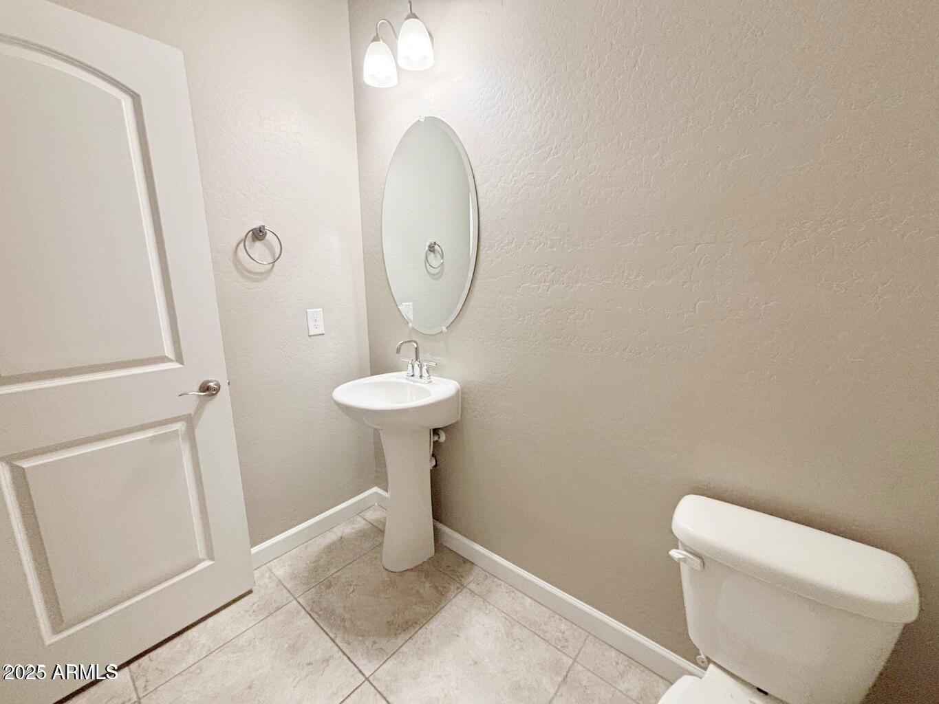 1255 North Arizona Avenue, Unit 1124 Chandler, AZ 85225 - Photo 9 of 29 a bathroom with a toilet sink and mirror