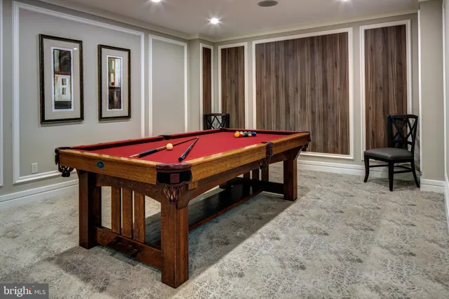 a room with pool table and windows
