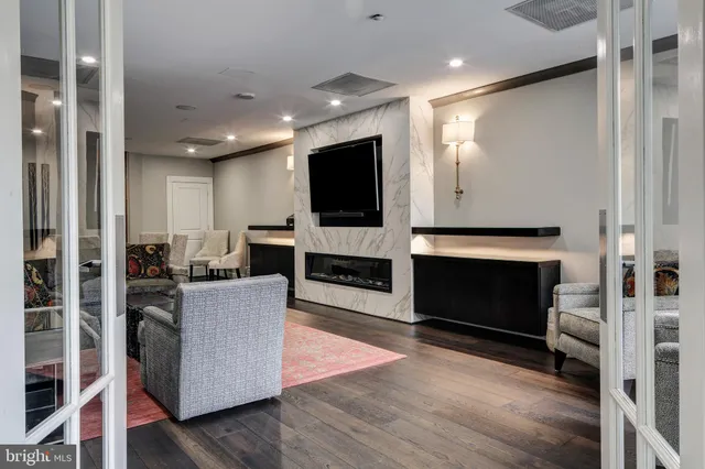 a living room with furniture a flat screen tv and a fireplace
