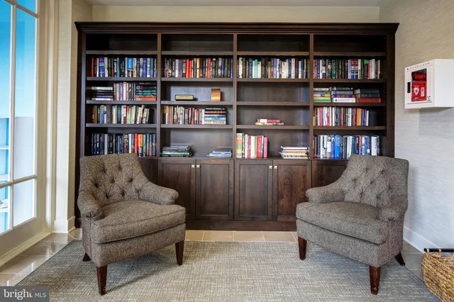a living room with furniture and a book shelf
