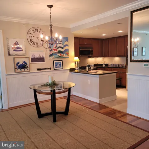 a kitchen with stainless steel appliances granite countertop a sink a stove and a wooden floors