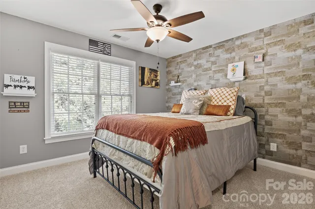 a bed sitting in a bedroom next to a window