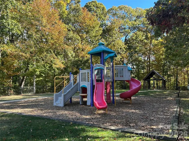 a view of outdoor space with playground and green space