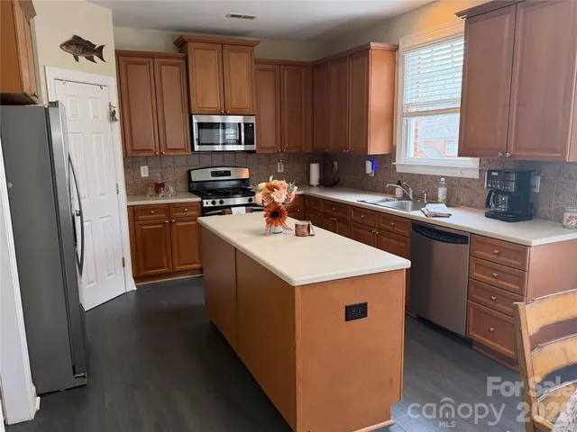 a kitchen with a sink stove and refrigerator
