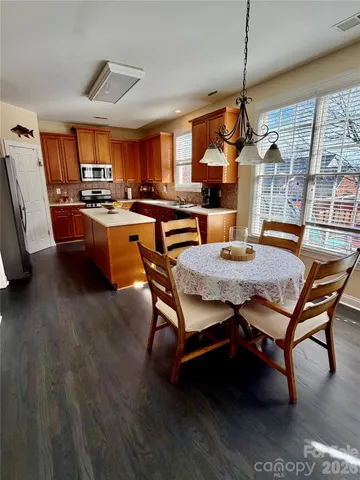 a dining room with furniture a rug and wooden floor
