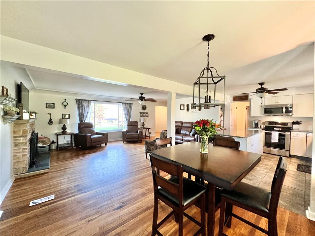 2175 Frew Mill Road New Castle, PA 16101 - Photo 7 of 25 a view of a dining room and livingroom with furniture wooden floor a chandelier